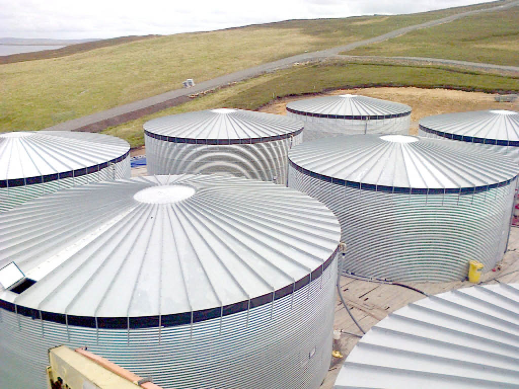 Aerial view of steel water tanks in the North of Scotland.