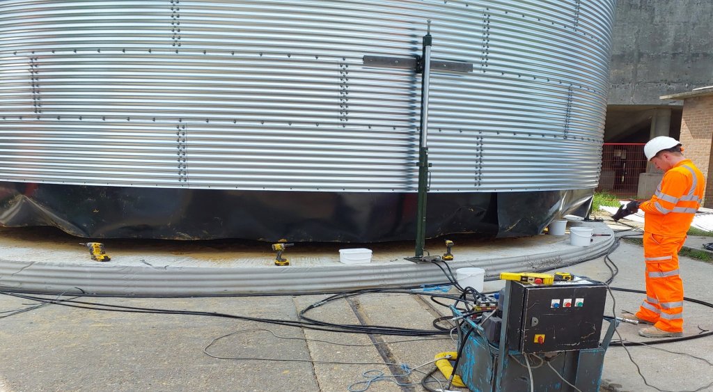 Man in hi vis testing water tank